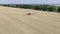 Massive wheat field on a sunny day, self propelled sprayer is driving