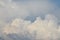 Massive white clouds over blue sky