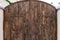 Massive wide antique brown wooden door with hooks and curtains, wooden texture