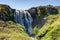 Massive wide beautiful waterfall in the middle of nature in Scotland.