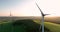 Massive windmills against a backdrop of verdant meadows 4k