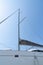 Mast of a modern sailing boat in a blue sky