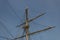 Mast of an old sailing vessel, rigging lines with block and tackle
