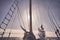 Mast of an old schooner sailing at sunset