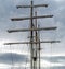 Mast, rigging and furled sails on a tall ship / sailing ship