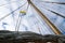 Mast, ropes and sails collected from an old sailboat seen from below