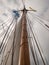 Mast, ropes and sails collected from an old sailboat seen from below