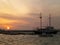 Mast of the sailboat against beautiful sunset sky over the Old Port of Mykonos