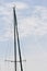 A mast from a sailboat against the blue sky