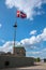 Mast of a ship with the Danish flag blowing in the wind on the Copenhagen waterfront