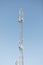 Mast or tower for mobile phone communication in bright sunshine and blue sky. Relay tower internet 4G