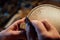 Master artisan luthier working on the creation of a violin. painstaking detailed work on wood.