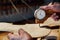 Master artisan luthier working on the creation of a violin. painstaking detailed work on wood.