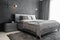 Master bedroom for a lonely stylish man, a bachelor. Modern room with trendy gray interiors, large king-size and lamps.