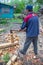 Master carpenter professionally working with an ax