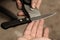 The master checks the sharpening of a knife from Damascus steel