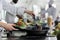 Master chef hands cooking beef patty in hot pan while cooking gourmet dish for dinner service