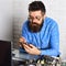 Master of computers. Bearded hipster works on fixing digital hardware. Assemblying of electronic devices. Bearded man