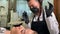 Master cosmetologist dances funny during permanent makeup of eyebrows