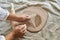 master craftsman rolls the clay on the table, transfers the napkin pattern to the clay mass