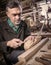 Master examines wood carvings, the carpenter checks the finished