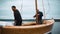 Master and his assistant work on wooden sailboat