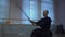 Master kendo performs kata, repeats cutting strikes with sword for workouts