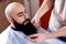 Master makes beards correction in barbershop salon