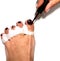 The master makes pedicures on toenails. Silicone finger device.