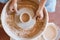 Master making a pot on pottery wheel, top view