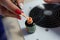 Master manicure, dips nail brush in a jar color orange gel nail