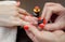 The master of the manicure paints nails with nail polish during the procedure of nail extensions with gel