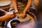 Master potter teaches the child to work on the Potter`s wheel. Close up shot