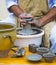 Master potter working at the potter`s wheel