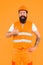 Master of quality. Master builder showing thumbs up on orange background. Bearded man master happy smiling in protective