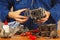 Master repairing parts of automotive engine in workshop