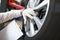 Master repairman holding documents and looking at quality of tires closeup