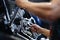 Master repairman repairing motorcycle with wrench closeup