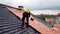 The master repairs the roof tiles of the house. Roofing, repair and renovation work. Generative AI