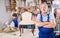 Master restoration worker dressed in overalls poses in working atmosphere of his workshop