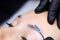 The master`s hands holding a micro brush that combs the eyebrows and models after the eyebrow lamination procedure