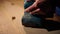 Master is sanding a wooden particle board in a furniture workshop with grinder