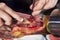 Master slicer taking iberian cured ham with tongs