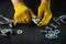 The master tightens the nut with a wrench on the bolt closeup. Working environment on a table in a workshop with tools. Free