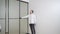 masters install sliding doors of wardrobe made of metal and glass.