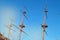 The masts of an ancient sailing ship with lowered sails in front of the blue sky and bright sunlight