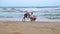 MATARA, SRI LANKA - MARCH 2014: The view of a three local kids playing on a beach in Matara. Matara is a major city in the