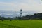 the Mataram Metro Monument is photographed from afar with a view of the green expanse of rice fields