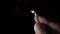 A match stick held in fingers ignite catches fire