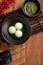 Matcha big tangyuan and matcha soup on wooden table